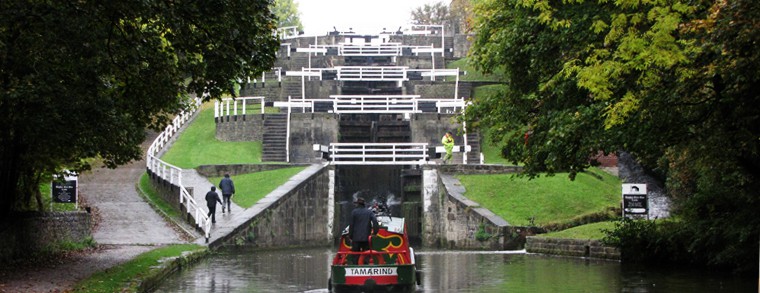 The Snaygill narrowboat Tamarind approaching the bottom gates of Bingley Five Rise Locks